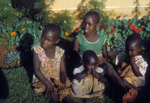 Four girls sitting in front of flowers