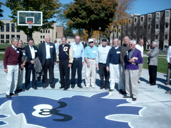 Men posing on a basketball court