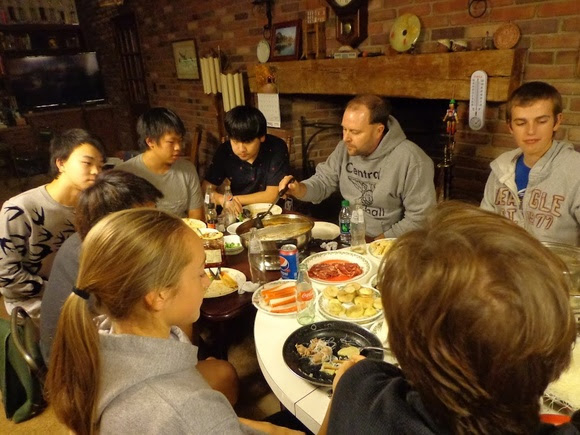 Several people eating at a kitchen table