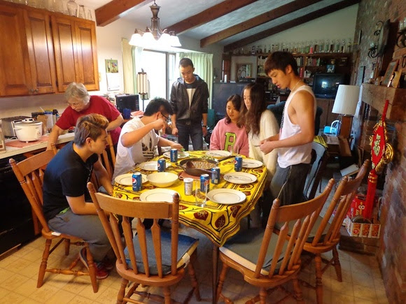 Several people preparing dinner